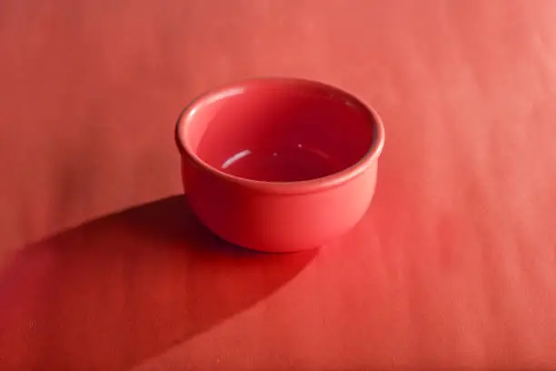 red porcelain bowl isolated on red background, kitchen utensils