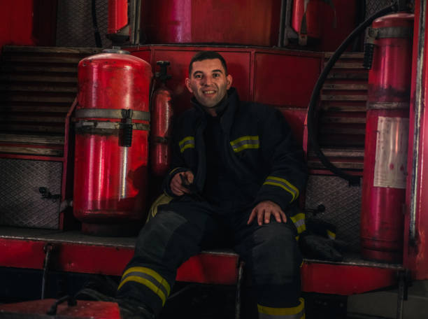istock Portrait of young fireman standing inside the fire station 1366688904