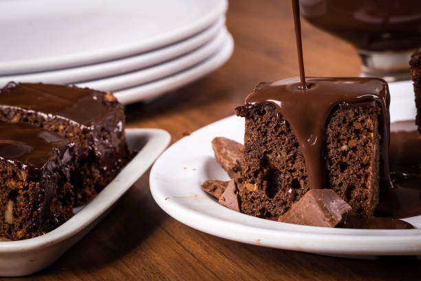 istock Brownie with chocolate sauce on white plate on wooden table 1366689191