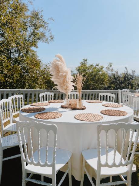 round table setup with pampas and wicker base for weddings