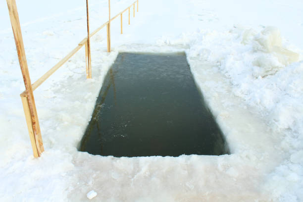 istock The hole for baptism. Epiphany bathing. Close-up on a city pond. 1366691188