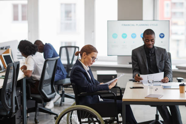 istock Businesswoman using Wheelchair Side View 1366691245