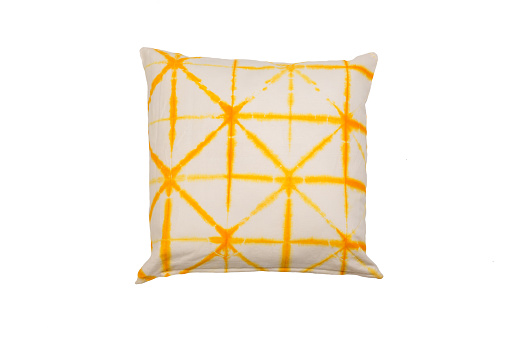 Decorative soft pillow, yellow tie dye pattern isolated on white background
