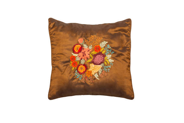 istock Decorative, brown soft pillow with embroidered flowers, isolated on white background 1366693219
