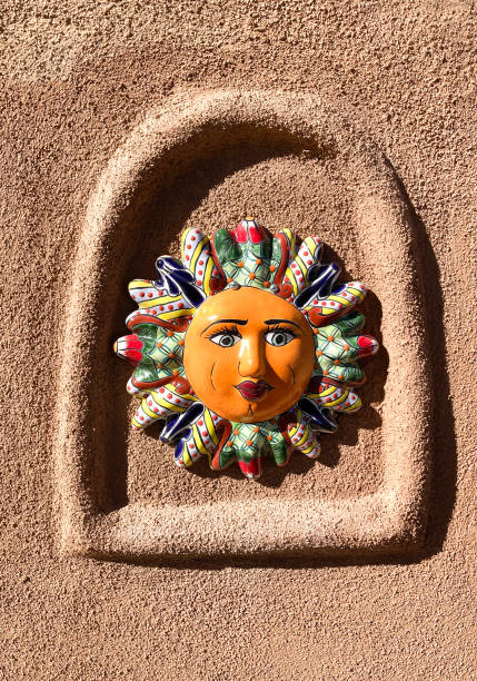istock Santa Fe Style: Colorful Mexican Ceramic Sun on Adobe Wall 1366693575