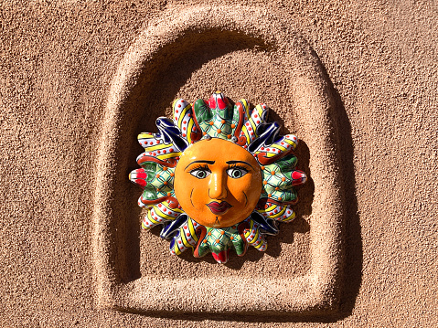 Santa Fe Style: Colorful Mexican Ceramic Sun on Adobe Wall