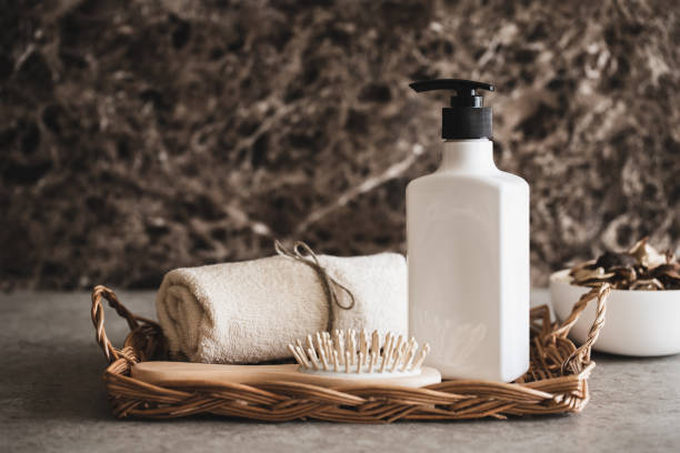 bath time. shampoo bottle and hairbrush. - hotel shampoo stockfoto's en -beelden