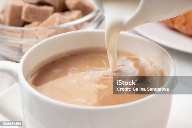 Pouring Milk Or Cream Into Freshly Brewed Coffee Close Up Stock Photo - Download Image Now