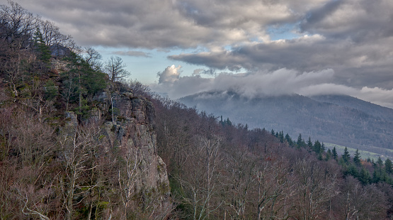 A view of a rock face and leafless trees in the Black Forest on a hill above Baden-Baden, Germany in the wintertime.