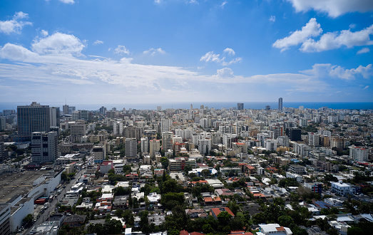 A cityscape of Santo Domingo, white clouds and blue sky