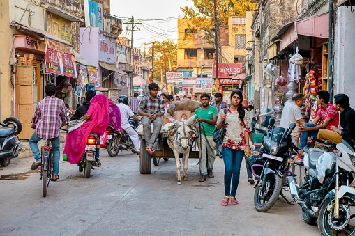 Mandawa, India - November 17, 2015. A mixture of old and new modes of transportation and clothing on a typical crowded street in Mandawa, Rajasthan.