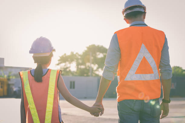 istock Father and daughter holding hand at Container cargo site. Business heir concept. 1366704890