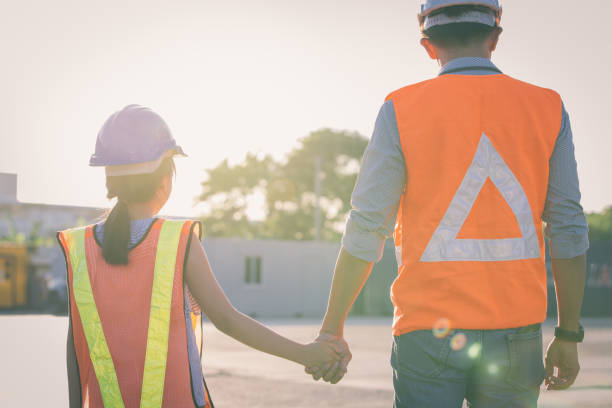 istock Father and daughter holding hand at Container cargo site. Business heir concept. 1366704892