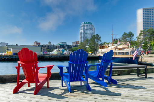 Three Adirondack chairs along the waterfront in Halifax, Nova Scotia, Canada.