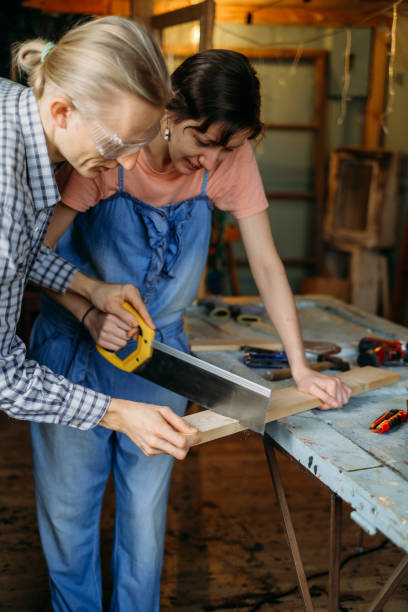 istock Woman working with wood in workshop. Reuse, reduce, recycle 1366707627