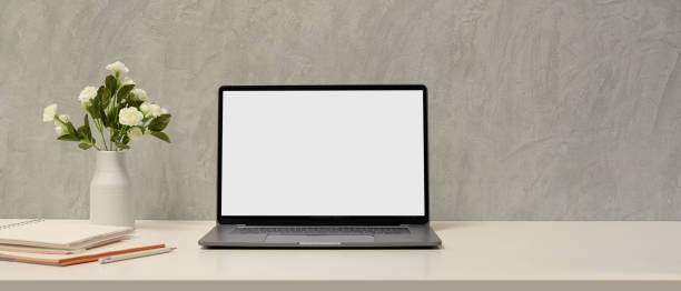 istock Simple minimal workspace with laptop blank screen mockup 1366709967