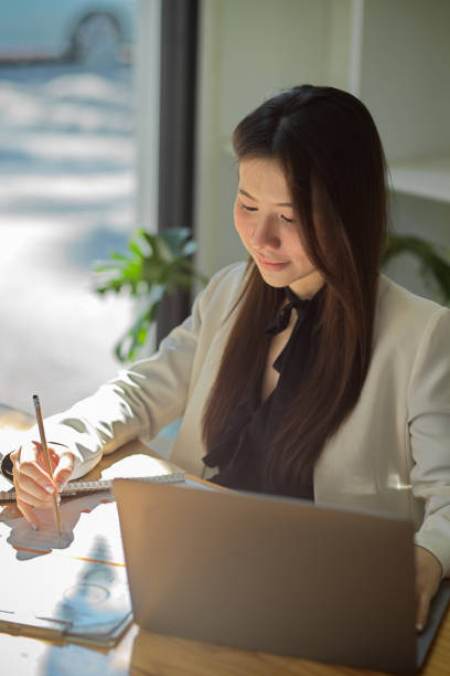 istock Businesswoman working on financial report. 1366710121
