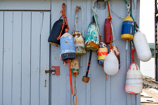 Colorful lobster buoys hanging on an old shed in Nova Scotia, Canada.