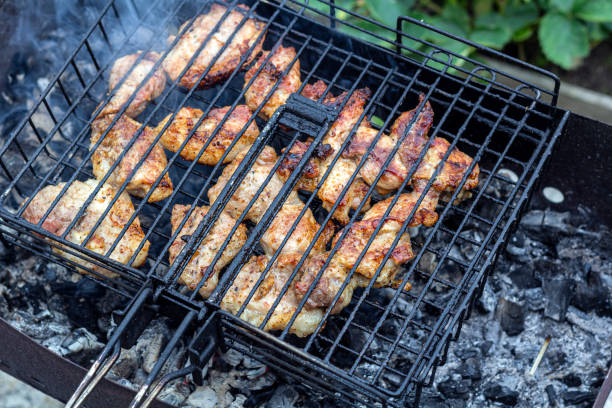 istock Process cooking meaty steak on a barbecue grill outdoors. Picnic, eating outdoors. Metal barbecue grill (brazier). 1366712507