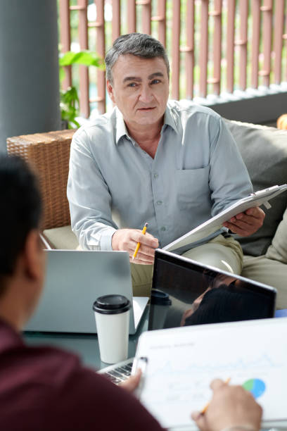 istock Senior Businessman Attending Meeting 1366713345