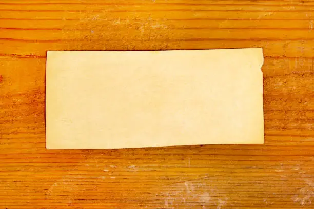 Old Blank Paper on a Wooden Planks Background closeup