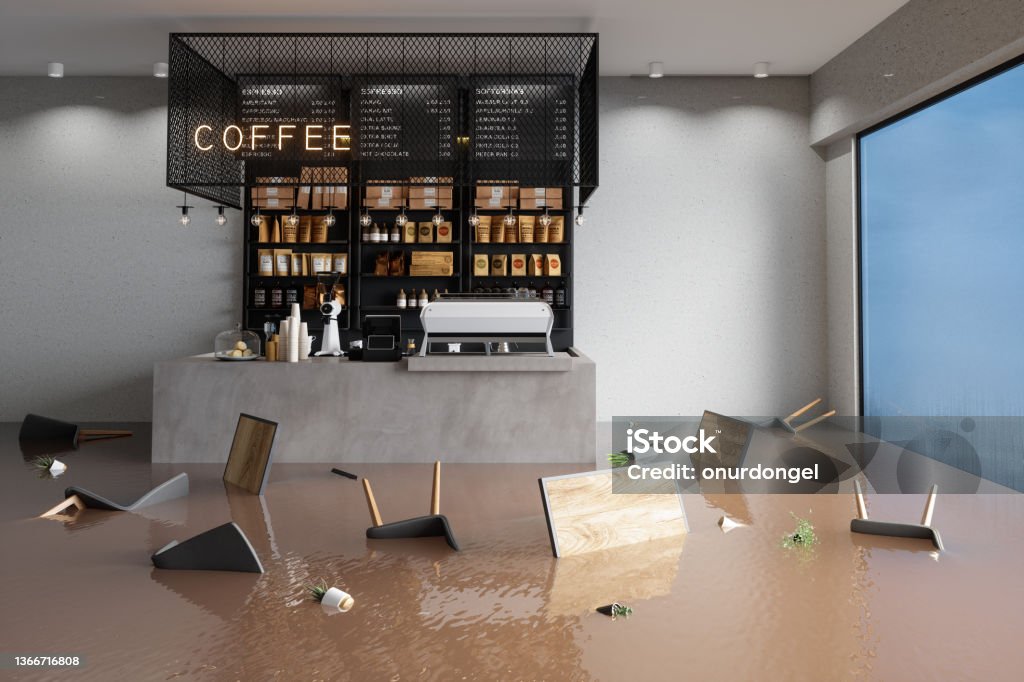Flooded Cafe With Chairs, Tables And Potted Plants Floating On Water Business Stock Photo