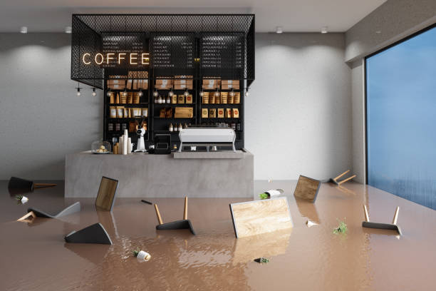 Flooded Cafe With Chairs, Tables And Potted Plants Floating On Water Flooded Cafe With Chairs, Tables And Potted Plants Floating On Water commercial kitchen photos stock pictures, royalty-free photos & images