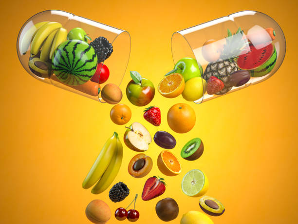医療カプセル、ビタミン栄養補助食品、健康栄養の概念で異なる果物。 - マルチビタミン ストックフォトと画像