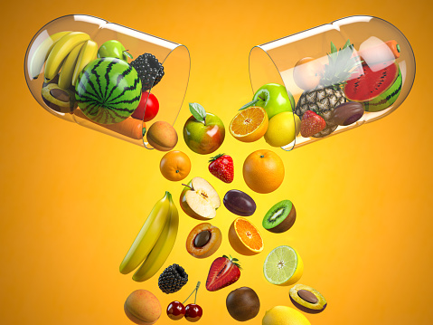 Top view of healthy fruits on white background. Grapes, pears, limes, lemons and bananas on white table.