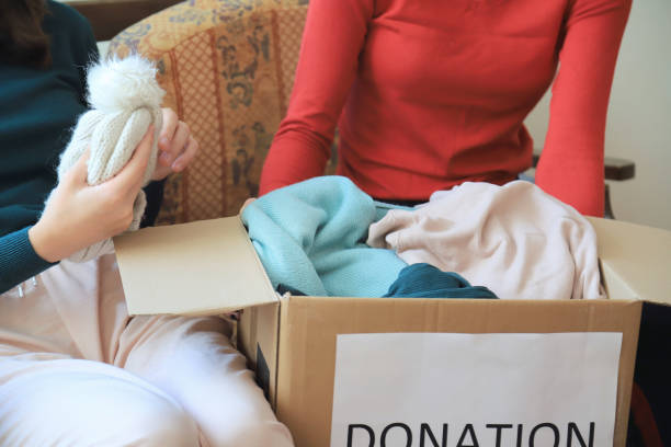 istock Two girls packing clothes for donation 1366722705