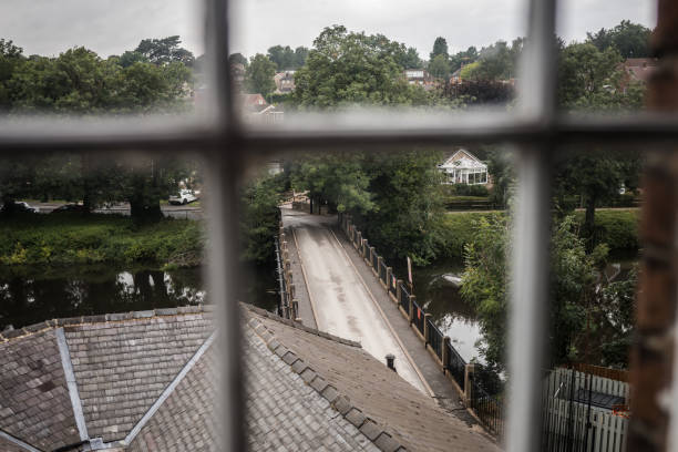 istock Old historic road bridge crossing river viewed through window 1366724107