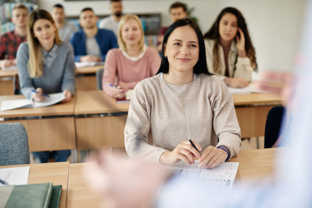 istock Young smiling woman paying attention during a lecture at the university. 1366724878