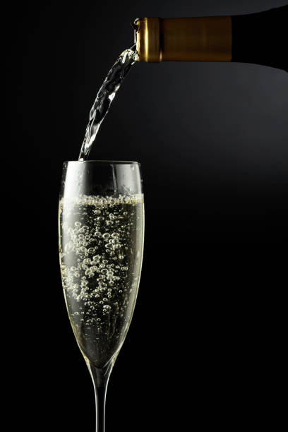 istock Sparkling wine is poured from a bottle into a glass. 1366725999