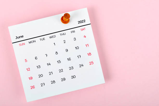 Calendar desk 2022 in June, The concept of planning and deadline with a push pin on the calendar date. Calendar desk 2022 in June, The concept of planning and deadline with a push pin on the calendar date. june stock pictures, royalty-free photos & images