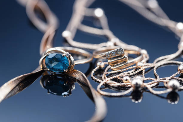 istock Gold rings with different precious stones lie surrounded by beautiful gold chains 1366731837