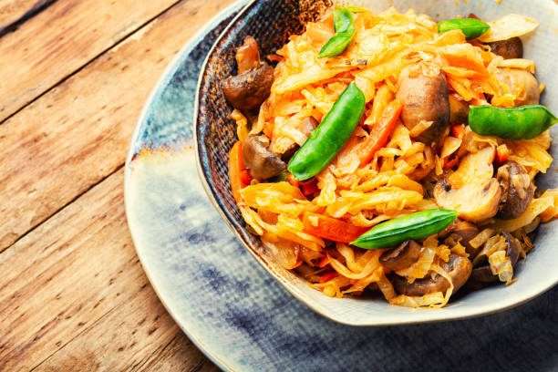 istock Tasty cabbage stewed with mushrooms. 1366732078