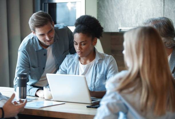 istock Smiling diverse colleagues discuss financial statistics, coworkers have cooperating working together at office meeting 1366732206