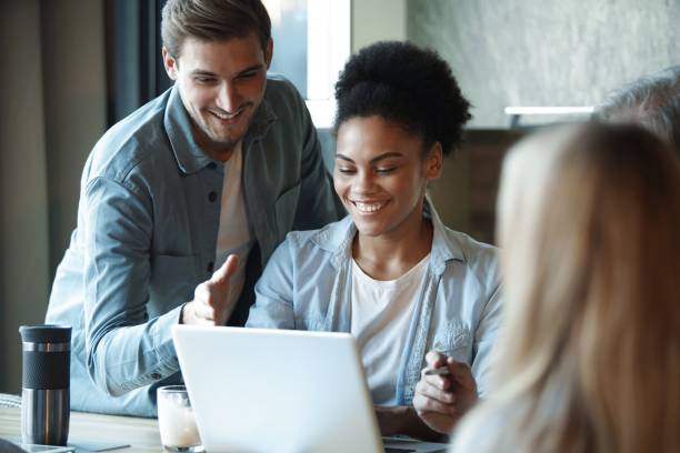 istock Smiling diverse colleagues discuss financial statistics, coworkers have cooperating working together at office meeting 1366732207