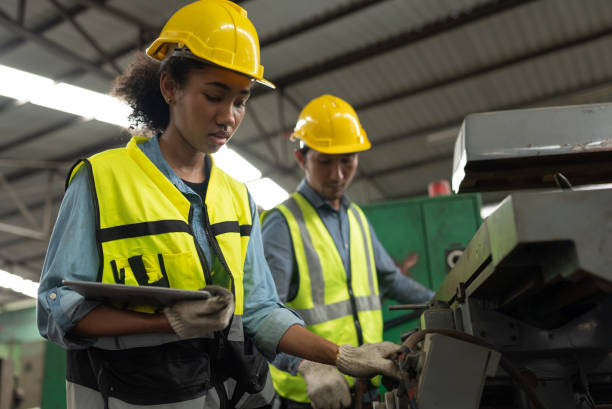 istock Engineer woman and team hard work with machine at factory 1366733308