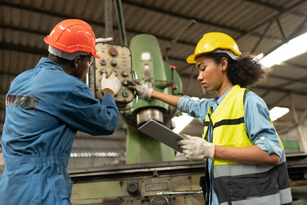 istock Engineer woman and mechanic hard work with machine at factory 1366733309