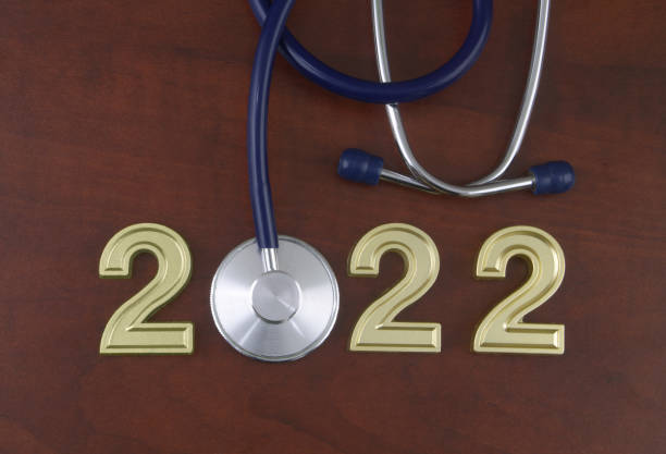 istock Stethoscope and numbers 2022 on wooden table. 1366733470