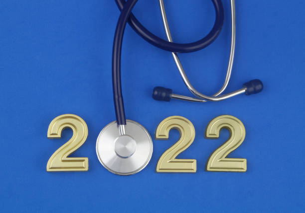 istock Stethoscope and numbers 2022 on wooden table. 1366733475