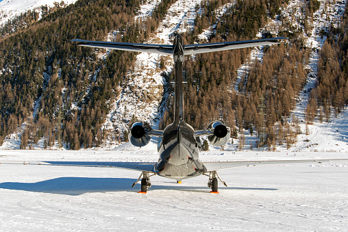 Private jets and helicopters in the airport of St Moritz Switzerland in winter time