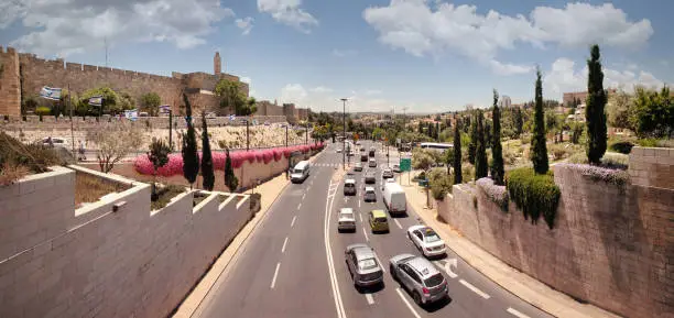 Jerusalem, Israel, May 24, 2017: The movement of cars on the road between the city wall and the valley of Gehenna of Fire. Old city