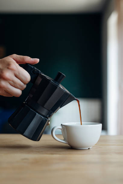 istock Unrecognizable Person Sipping Coffee from Stovetop Coffee Maker 1366738489