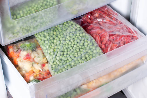 istock Frozen green peas in the freezer 1366739613