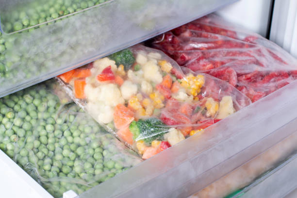 Plastic bags with different frozen vegetables in refrigerator. Plastic bags with different frozen vegetables in refrigerator. Frozen food frozen food stock pictures, royalty-free photos & images