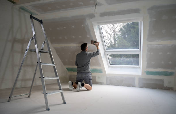 istock Man plastering drywall in a private house. 1366740952