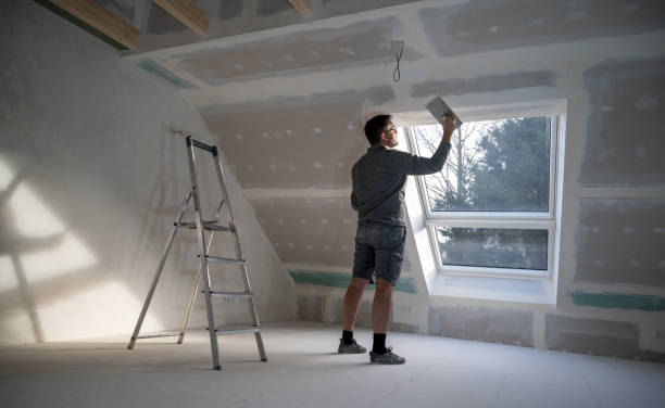 istock Man plastering drywall in a private house. 1366740968