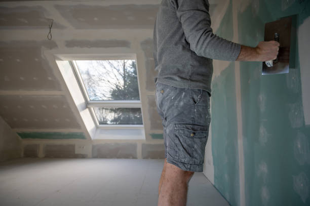 istock Man plastering drywall in a private house. 1366740986
